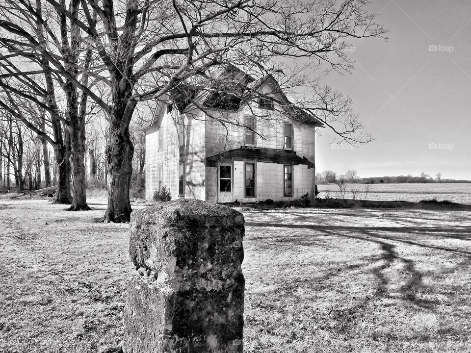 Old farmhouse in black and white on a winter day in Indiana 