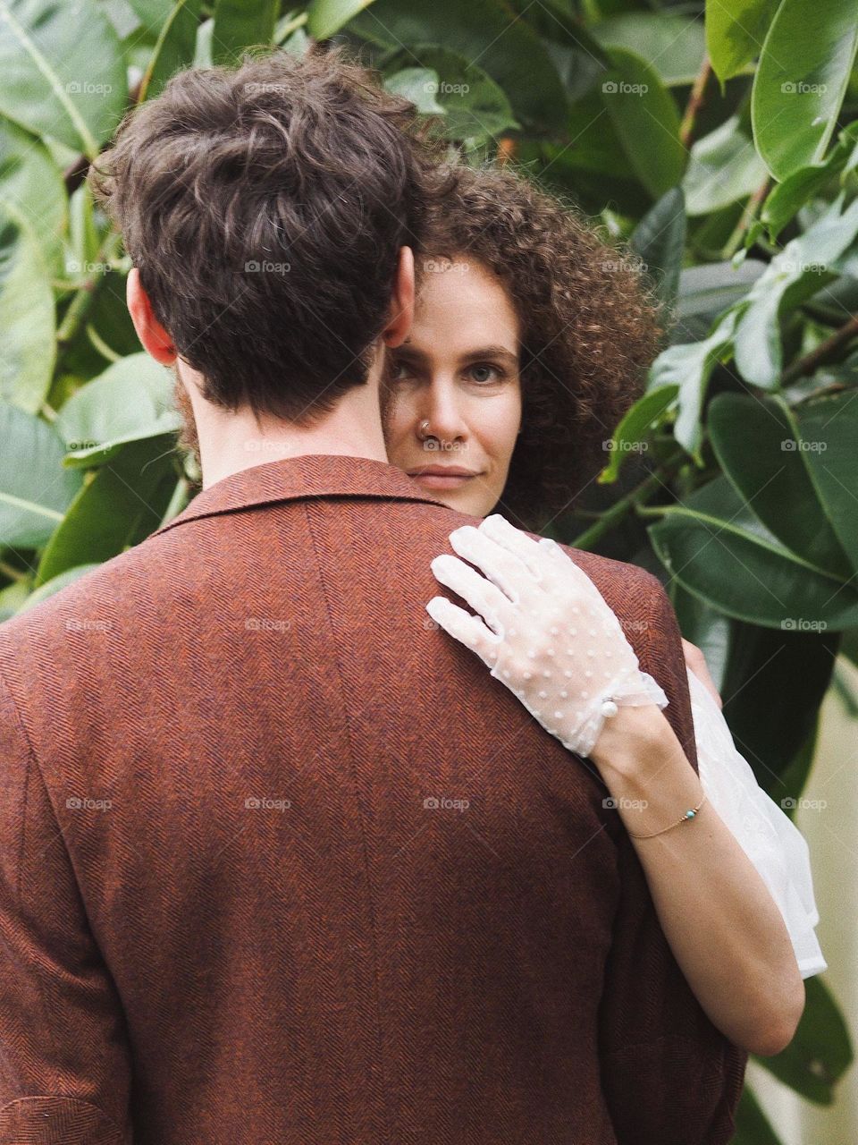 Young beautiful lovers in botanical garden 