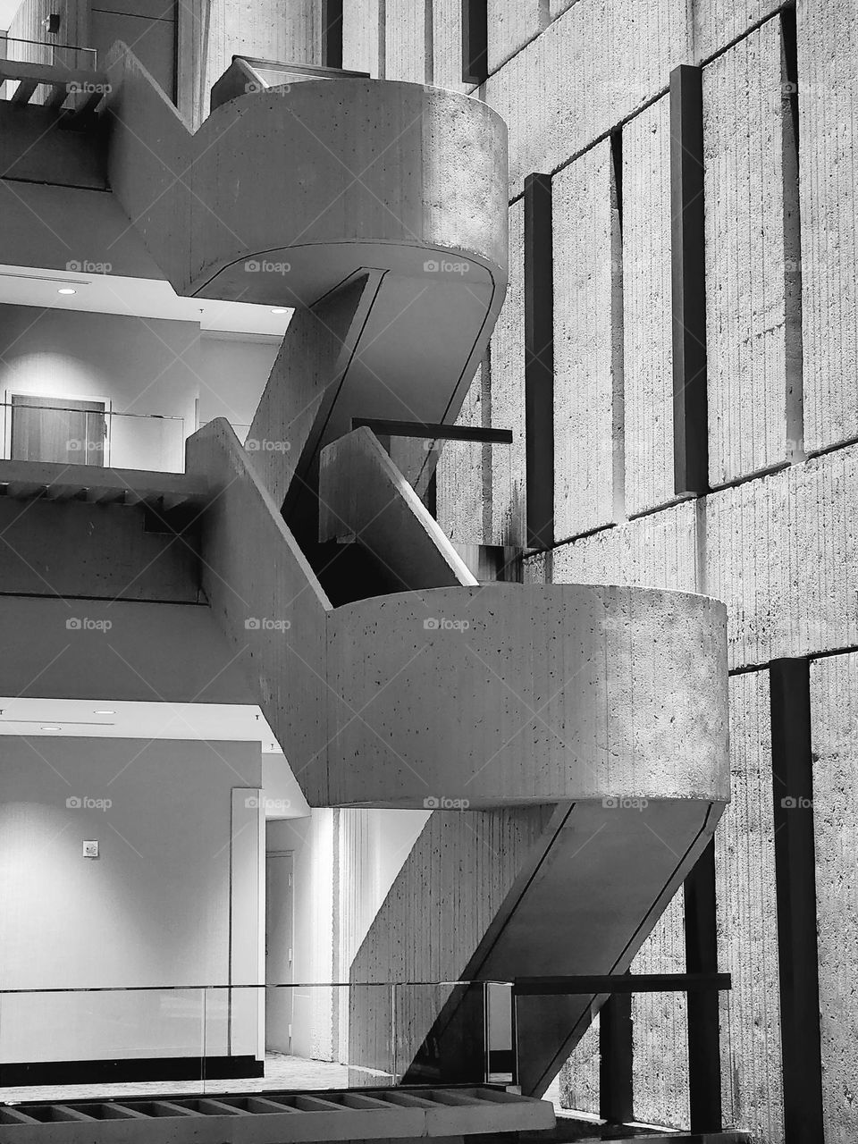An interesting staircase lends a creative architectural element to a hotel lobby in a large space