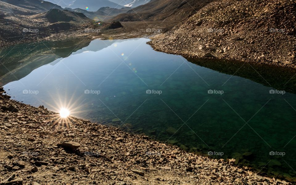 when I bought the sun down to the earth I deserve to win this mission ππ₯° just kidding. Reflection of gorgeous sunstar on the crystal clear lake water