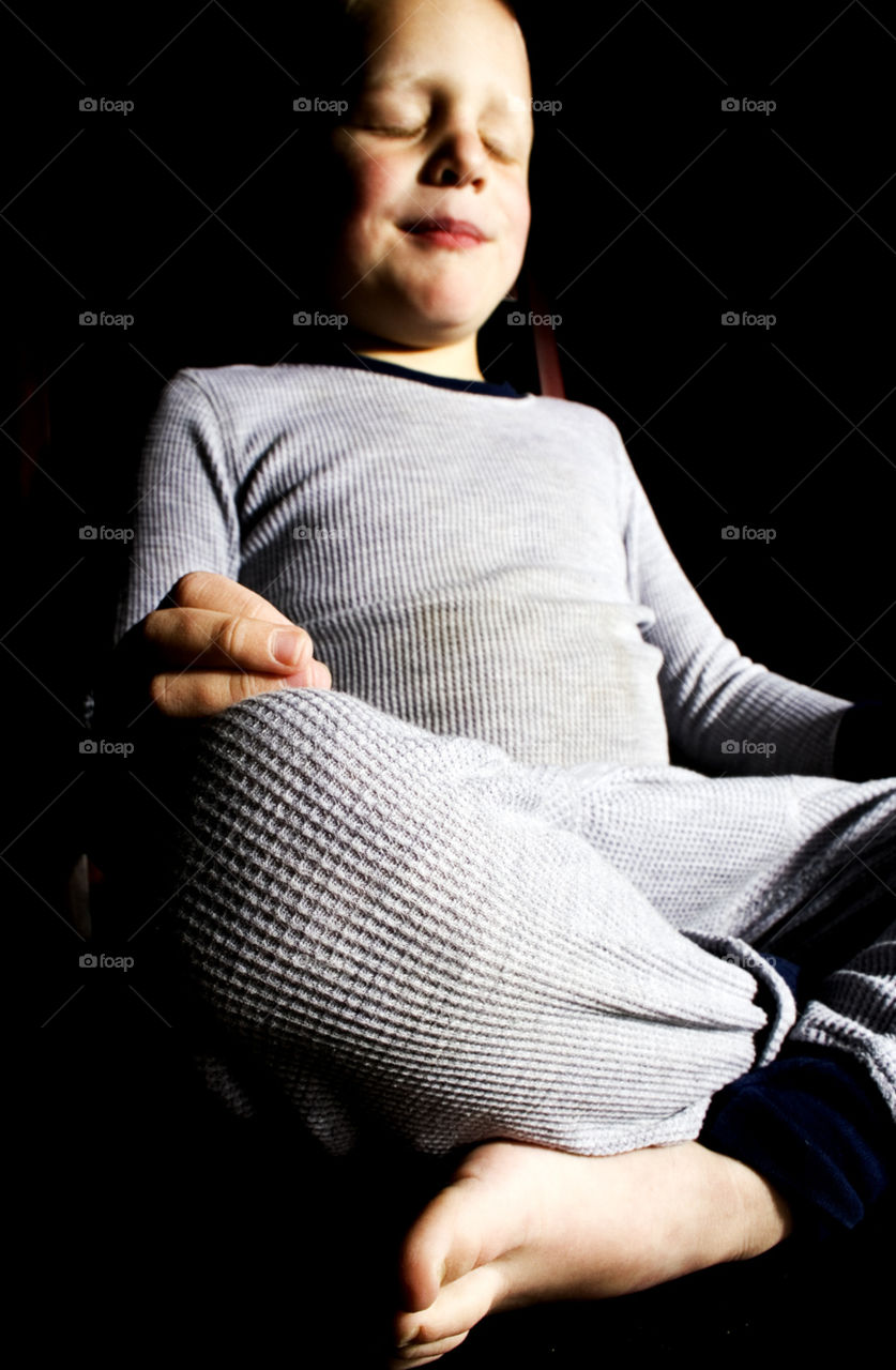 Yoga Boy. A child sits in a contemplative pose as he begins his day
