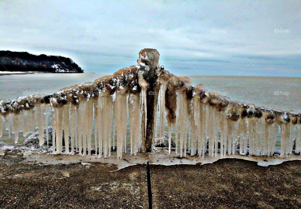 Nature creates a frozen angel out of the love locks off the pier of Lake Michigan. Photographer Lee La Beez of Beez Lee Art
