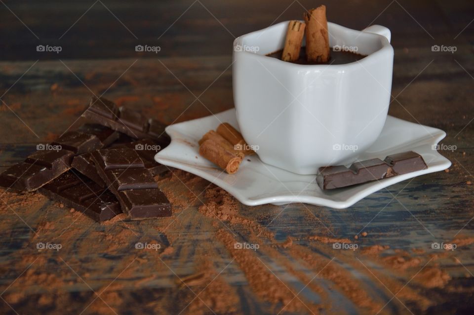 Cup of melted chocolate with cinnamon