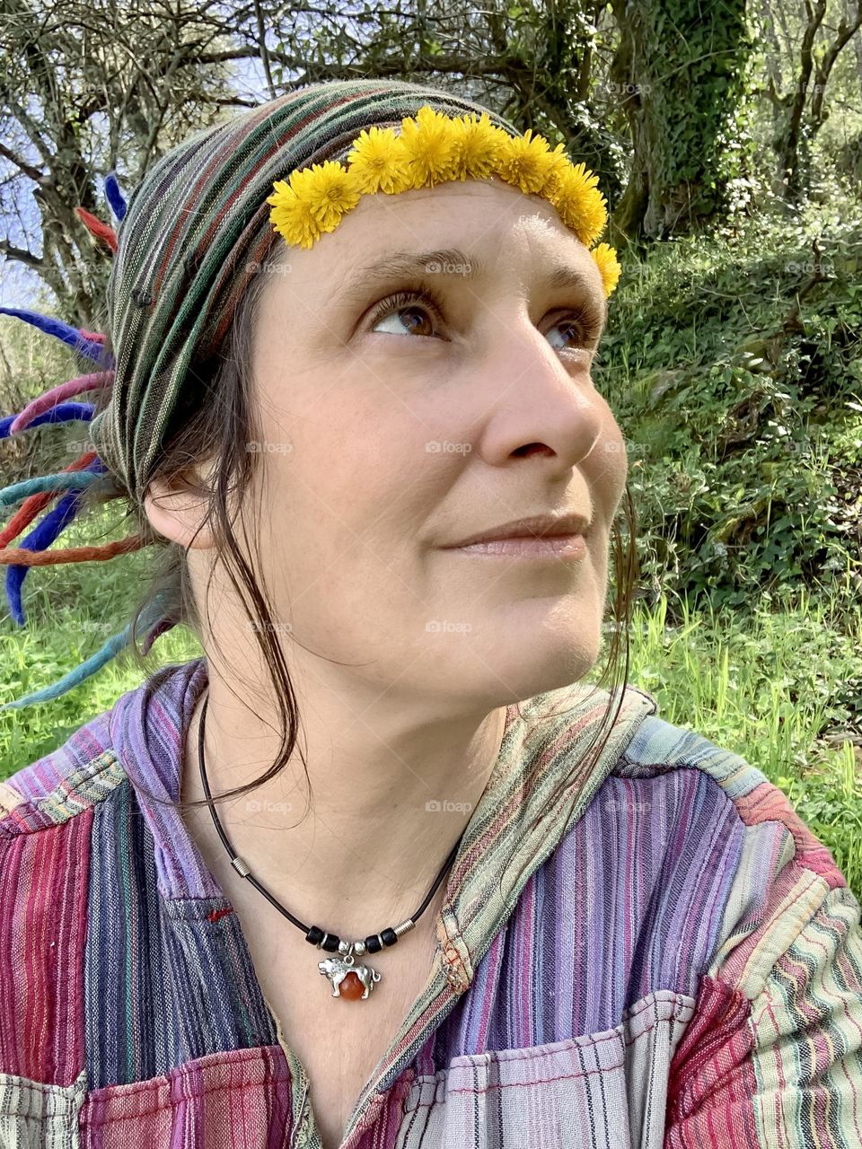 Self portrait in my hippy clothes with a row of yellow flowers in my hairband 