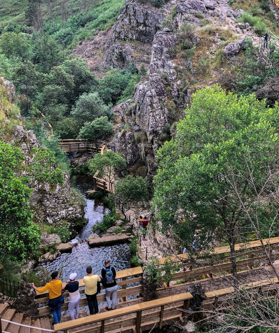 Hikers stop to enjoy the view near Penedo Furado