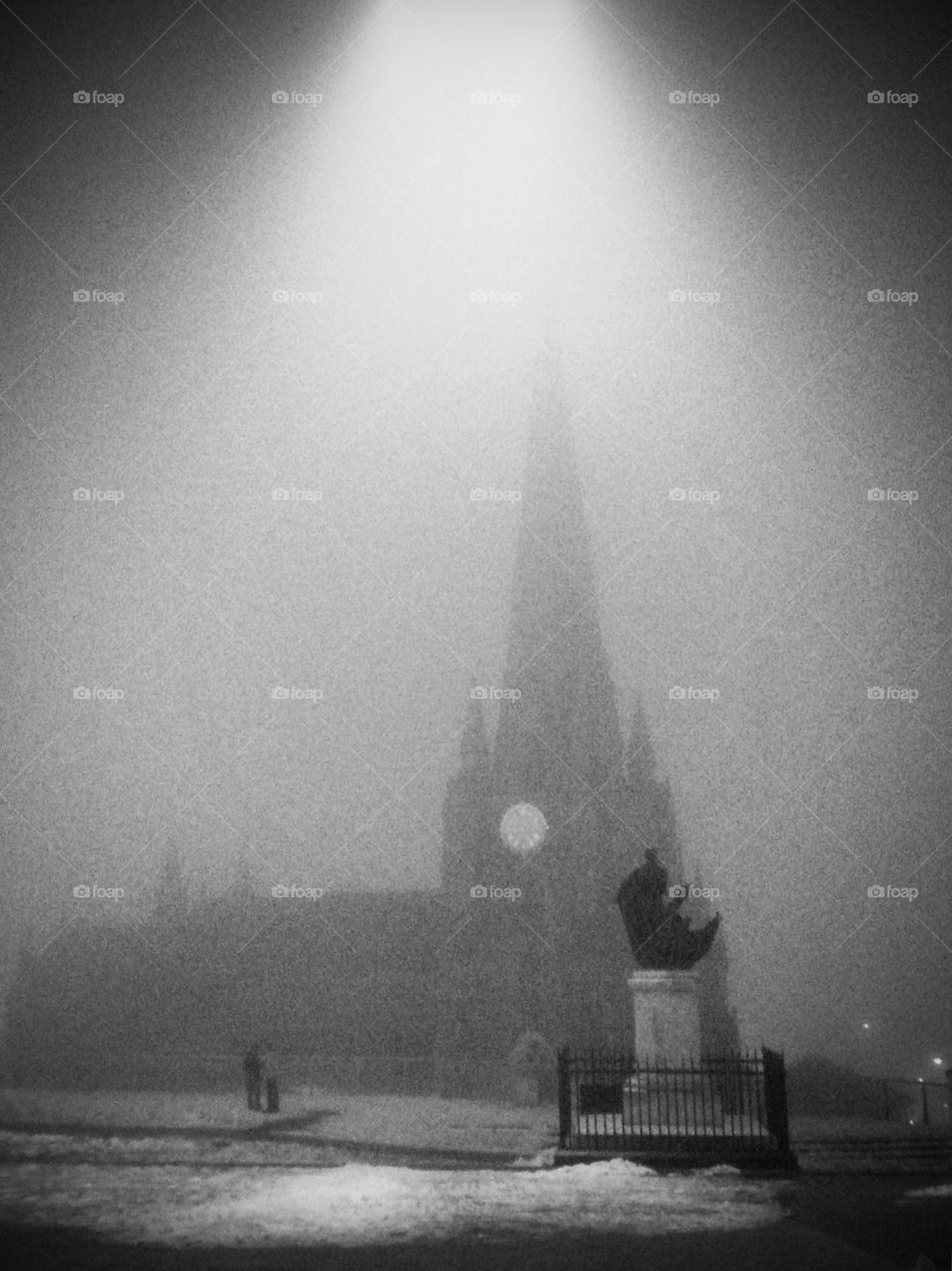 A church scene viewed at night through the mist.