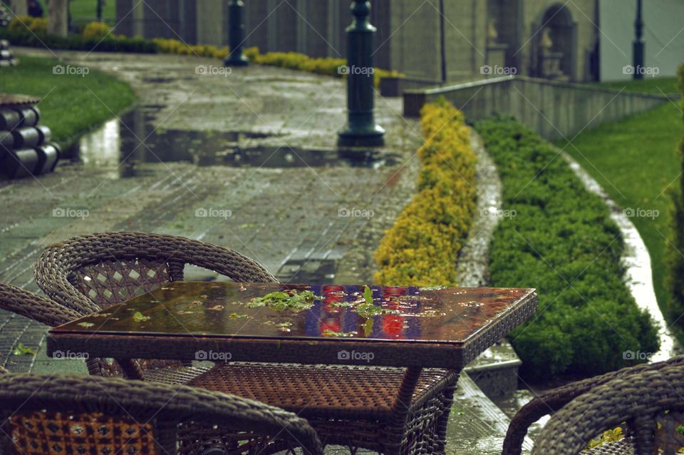 table and chairs of a summer street cafe with wicker tables and chairs