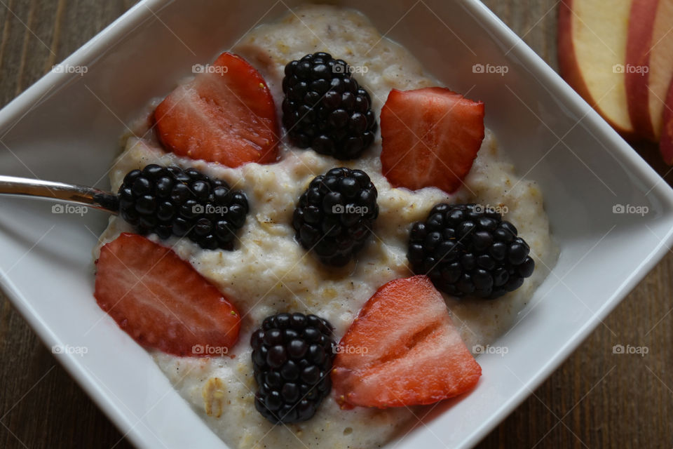 Bowl of oatmeal with strawberries and blackberries