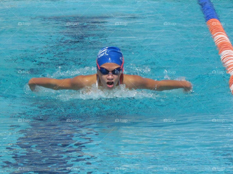 Young girl swimming butterfly in a compition