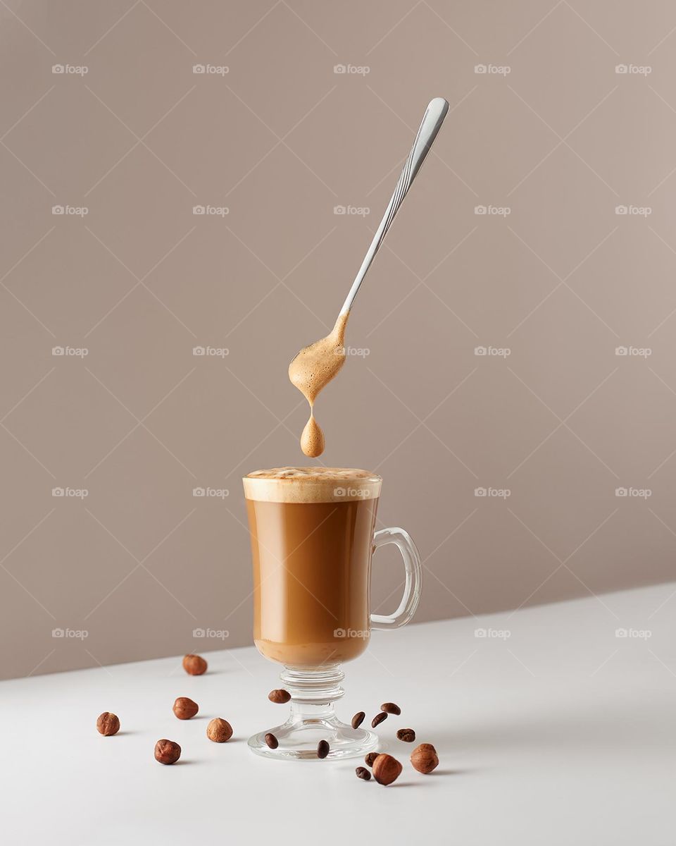 A glass of cappuccino with hazelnuts