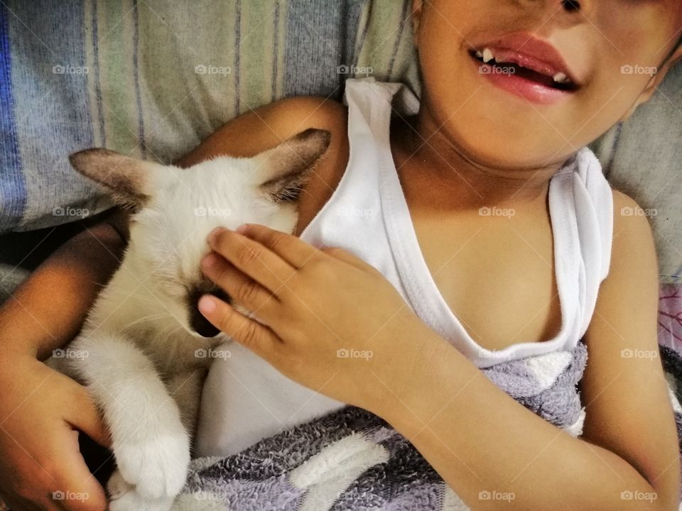 A funny kid and a funny kitten