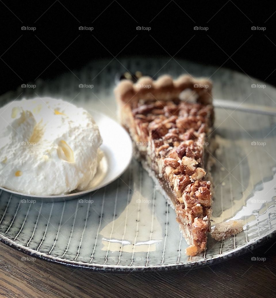 Pecan and syrup pie with wiped cream 