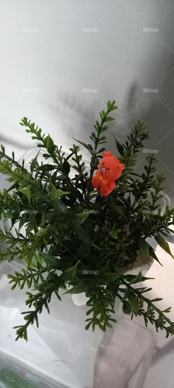 Artificial vase with one teddy bear