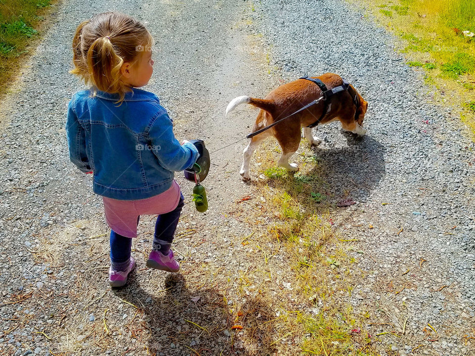 Little girl loves walking her doggy