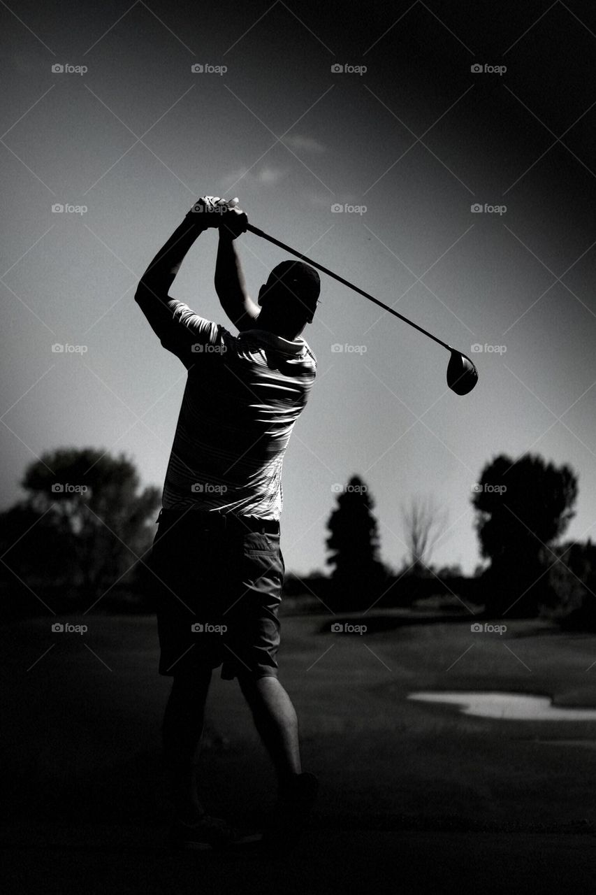 Rear view of a man playing golf