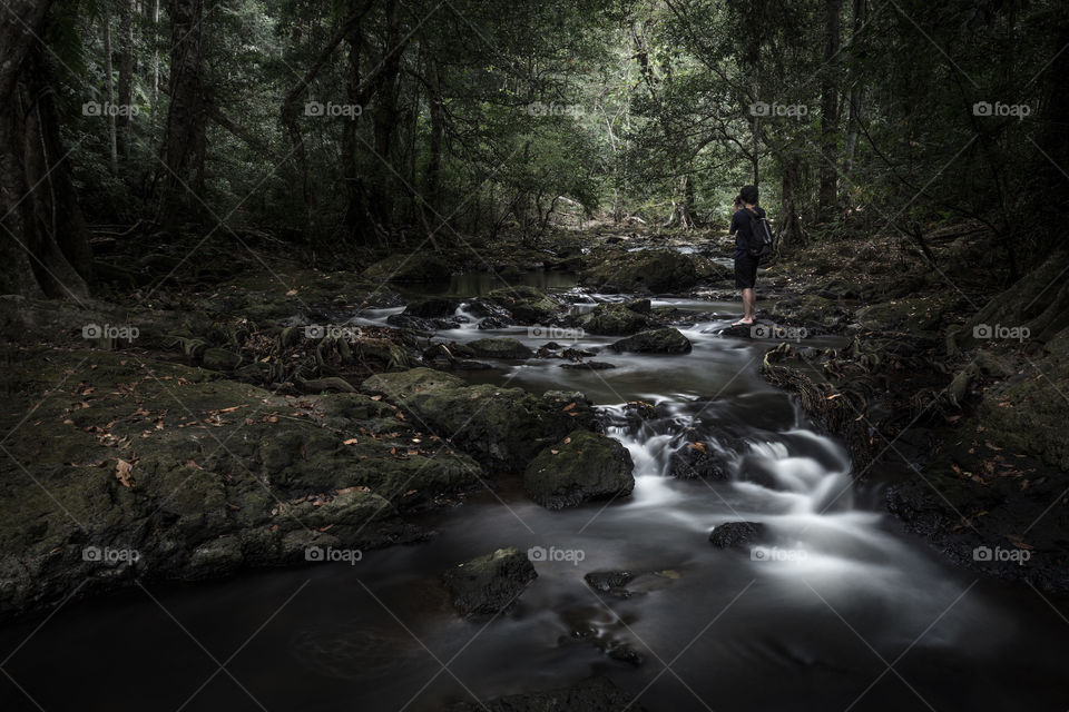 Photographer taking a photo in the waterfall 