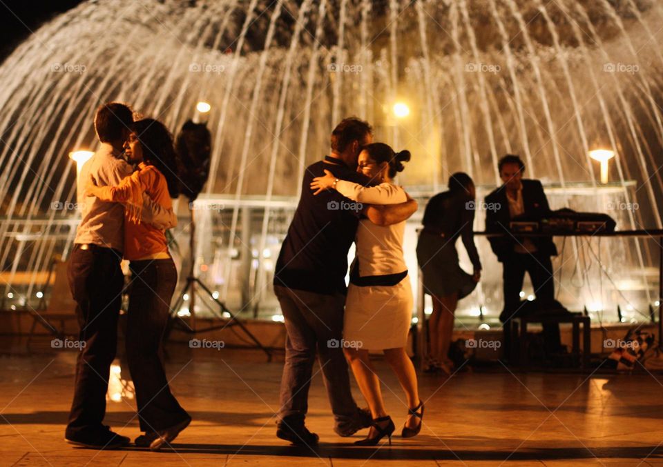 Couples dancing near fountains in old historical city, Lisbon, Portugal 