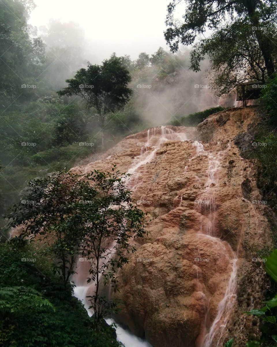 sulfur stones with hot springs in foggy view