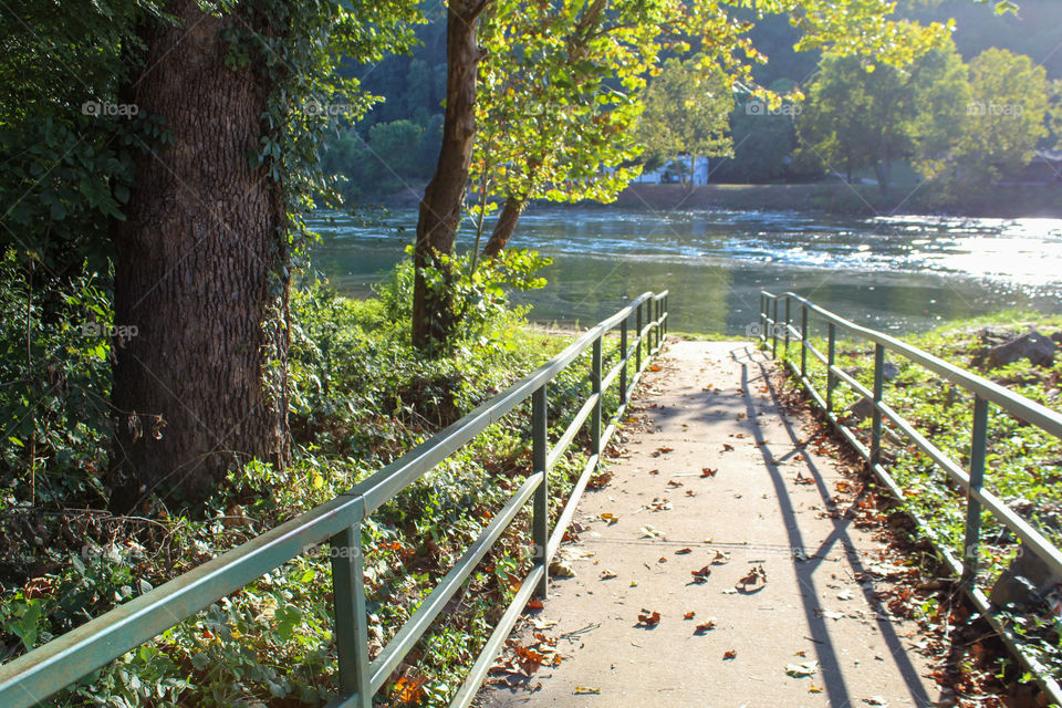 A green railed walkway down to the White River in Arkansas. 