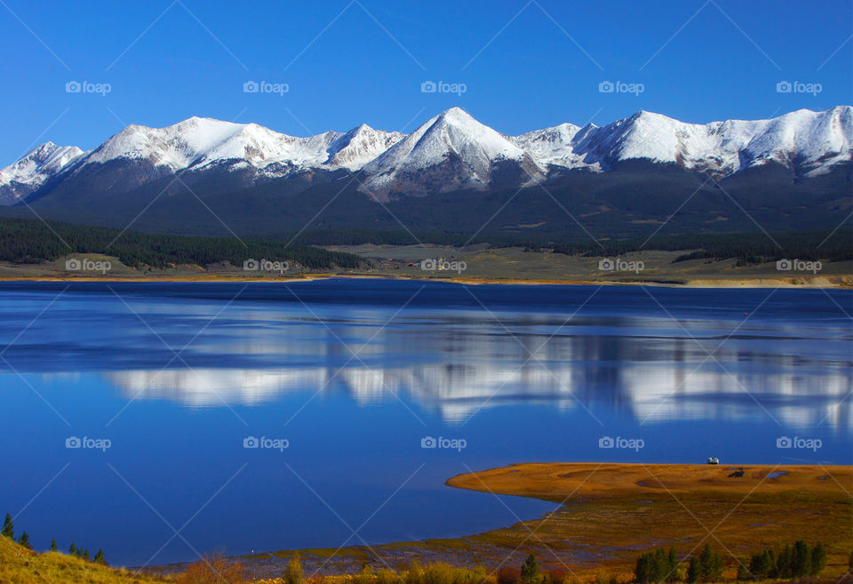 Snowy mountains reflection in lake