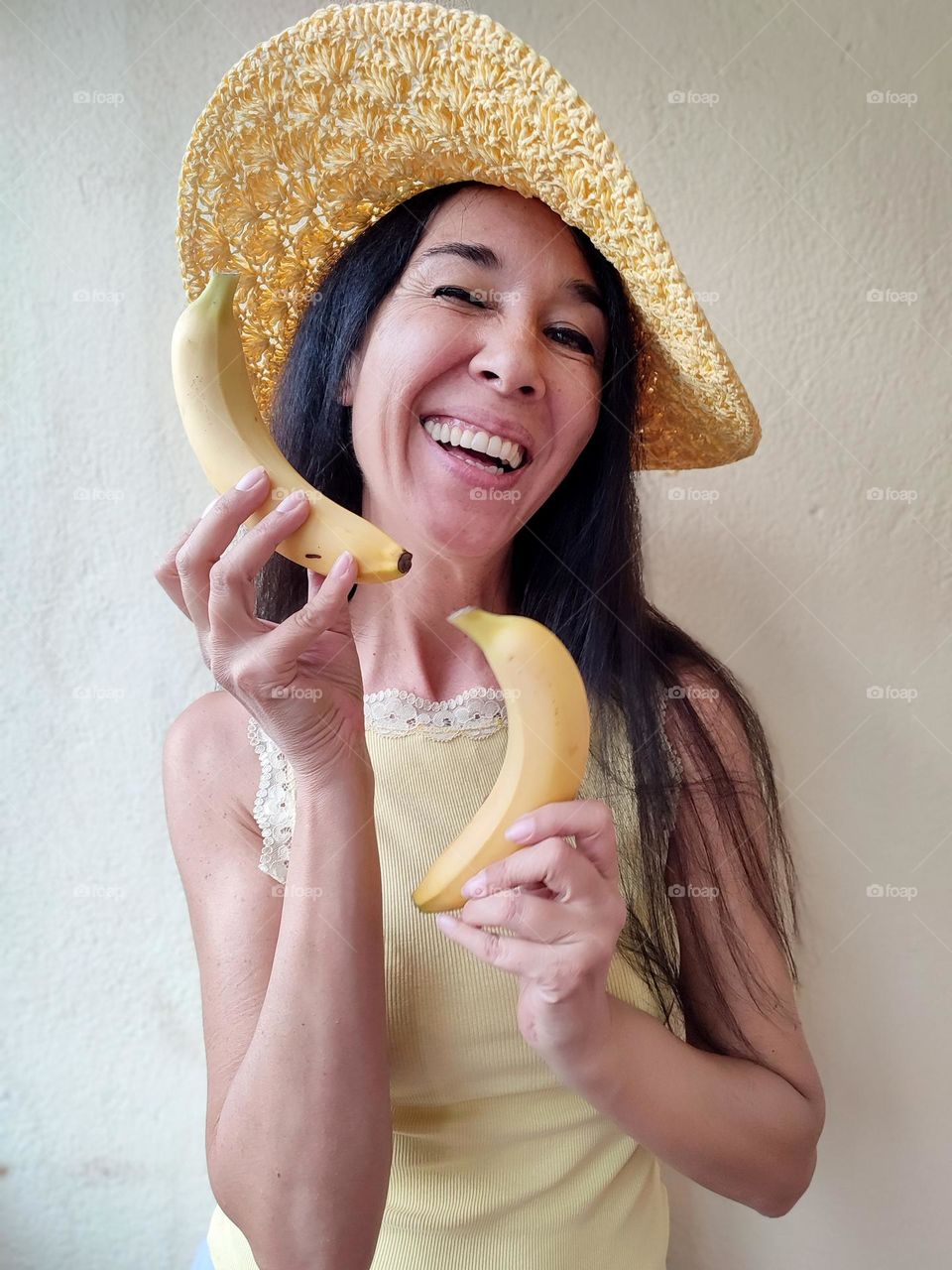 Funny Portrait of Beautiful Smiling Woman with bananas