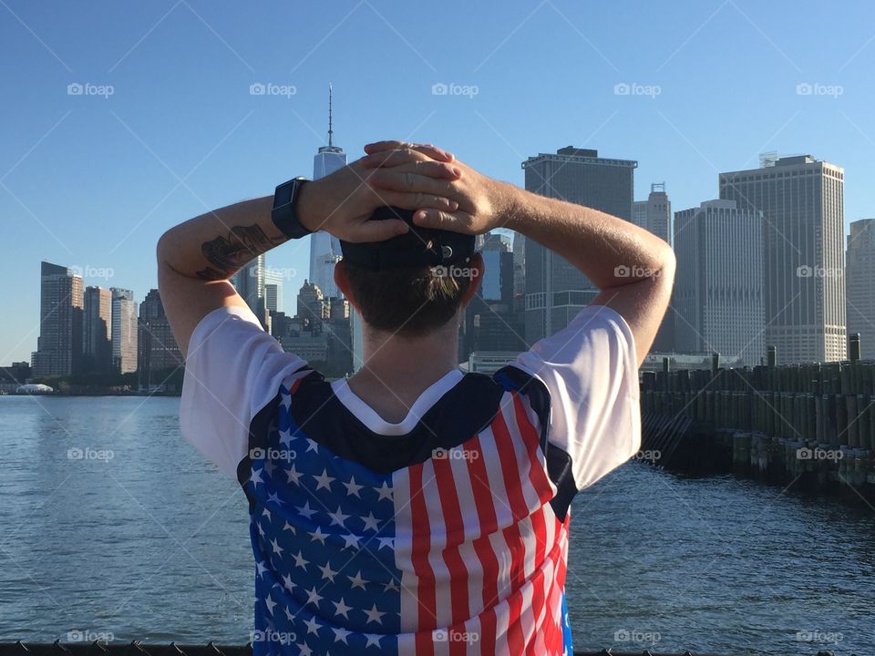 Man looks out on World Trade Center in patriotic attire