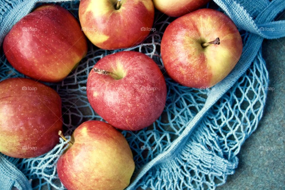 Fruits! - Apples in a light teal-colored string produce bag