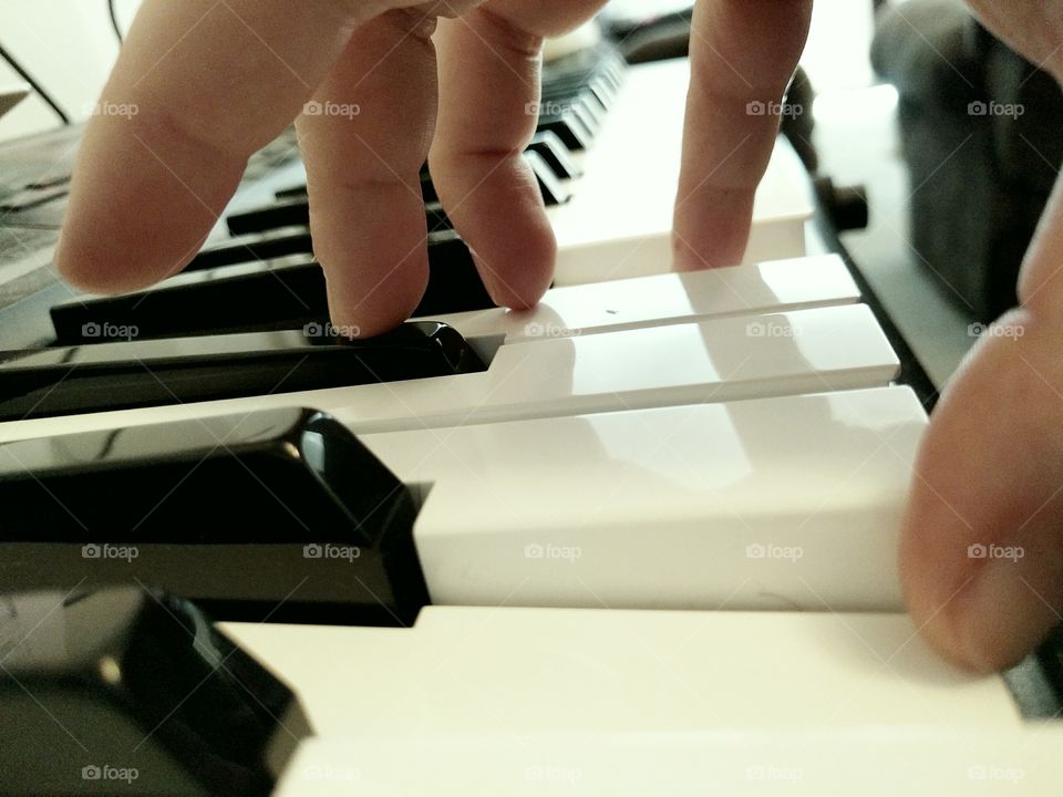 Hand Playing Piano Keyboard