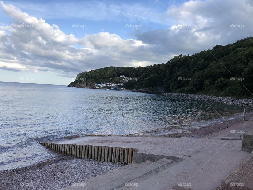 Oddicombe Beach looking peaceful and tranquil in the early evening summer sunshine.