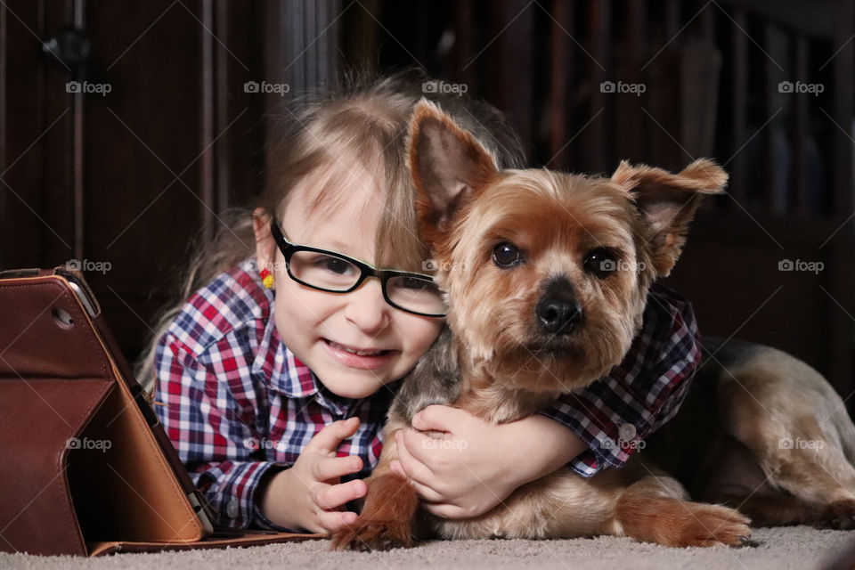 Child hugging her best friend