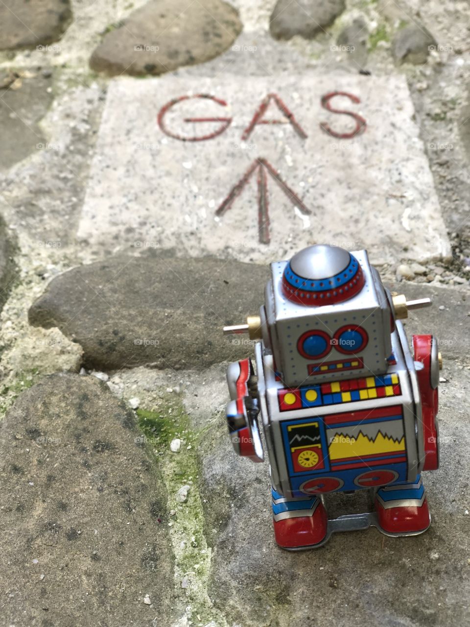 Gas direction with tin toy robot 