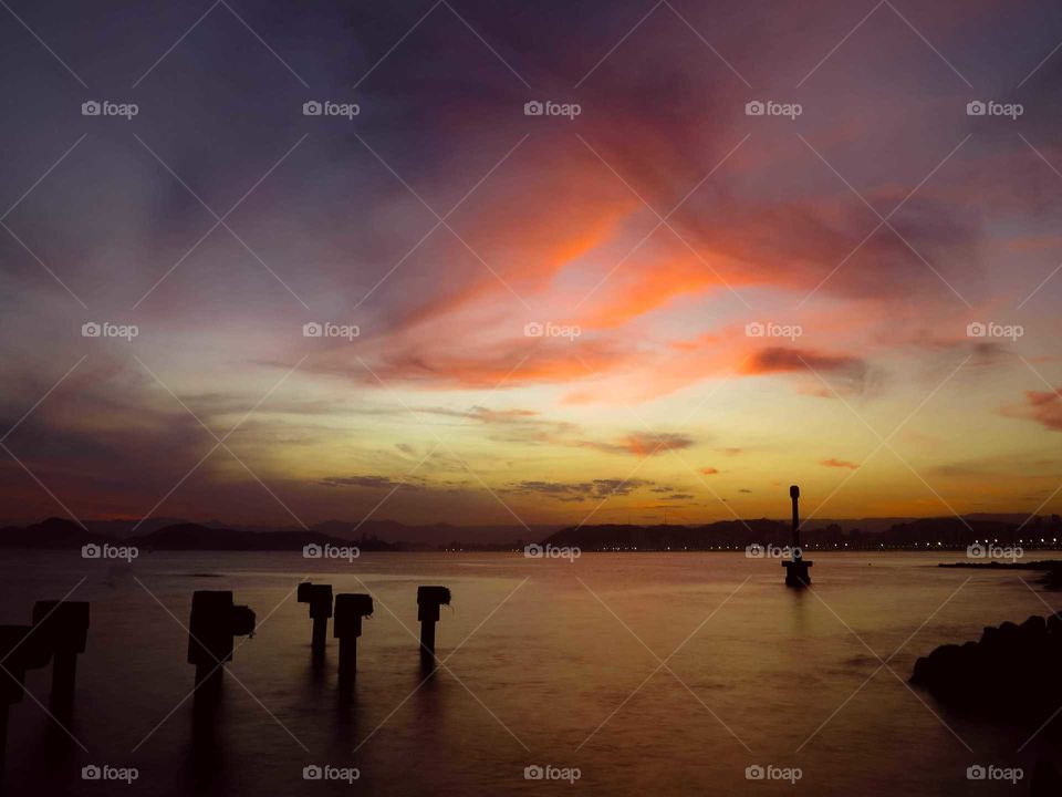 Beautiful Sunset, Golden Hour, at Santo's Pier in Brazil. Ocean Paradise, beautiful colorful sky.