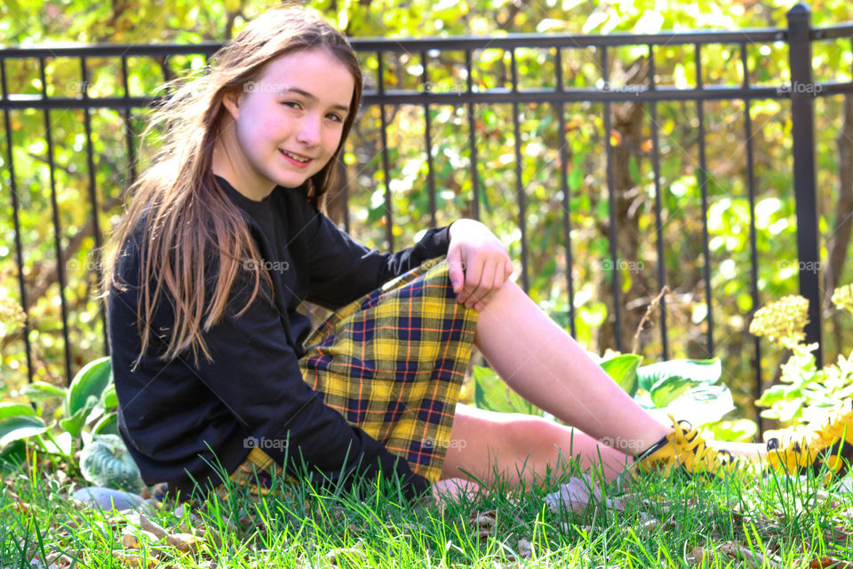 girl in yard in plaid