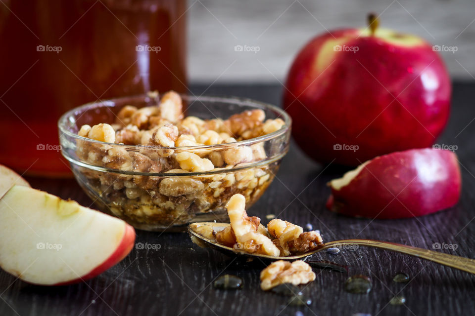 Healthy snacks with apples, nuts and honey