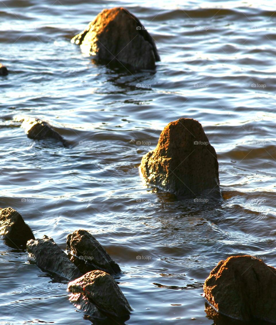 three rocks lining to great the sun