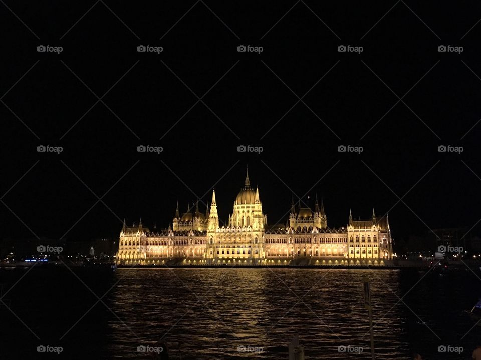 View of the Hungarian Parliament building at night from a boat on the Danube River. Budapest, Hungary. 