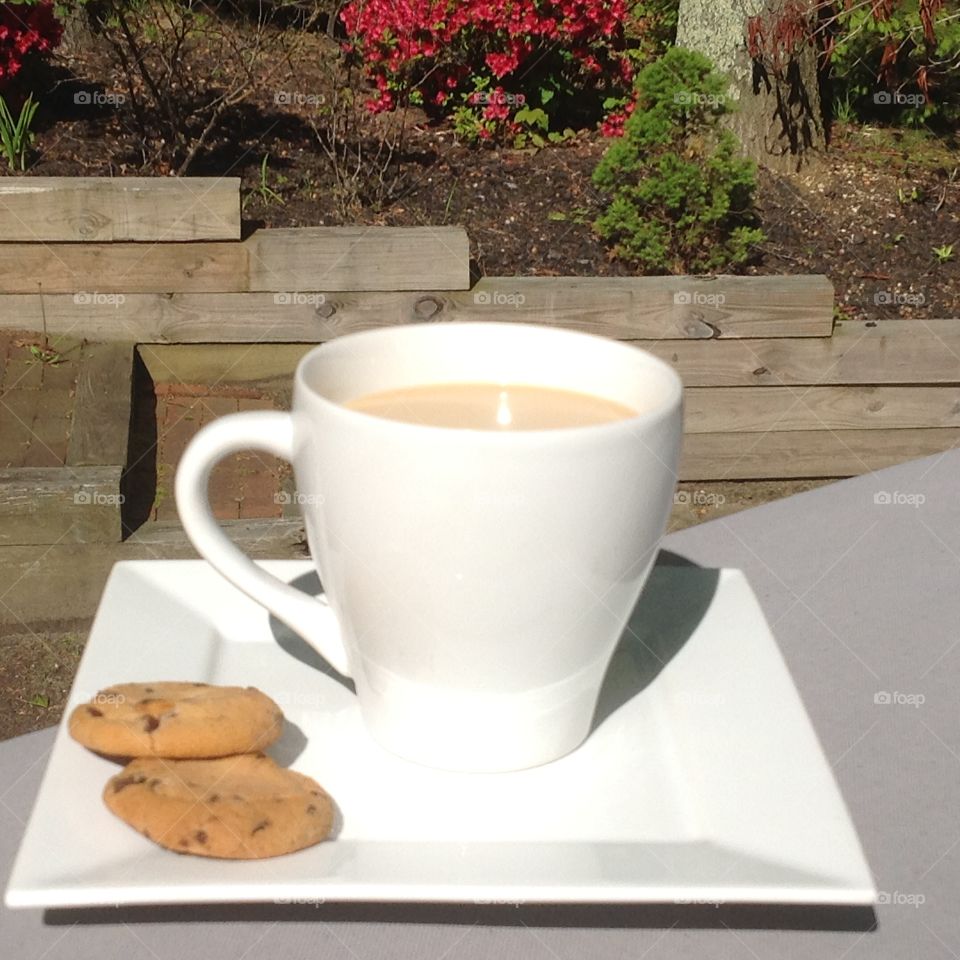 Enjoying a cup of coffee outdoors on a beautiful spring day.