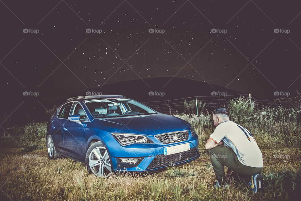 Owner with his vehicle at night