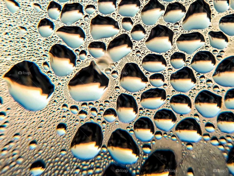 Water droplets on the window during sunrise in Poland
