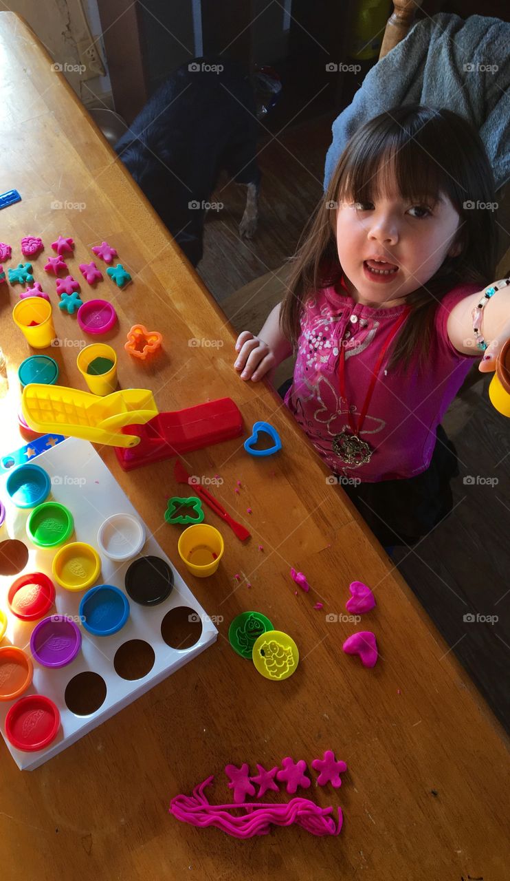 Elevated view of small girl playing with moulds