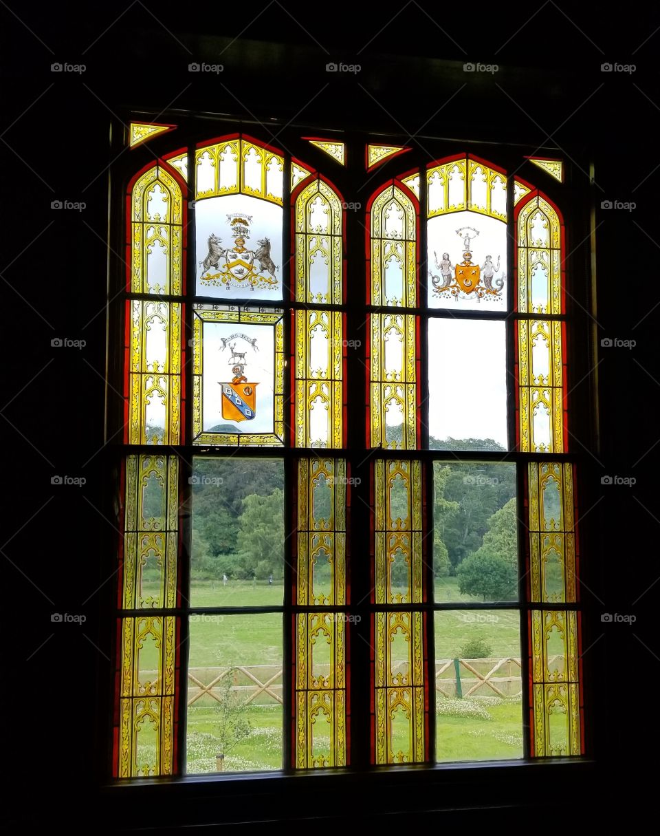 Looking out of a stained glass window into the countryside