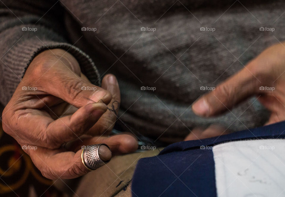 Craftsperson doing embroidery on cloth