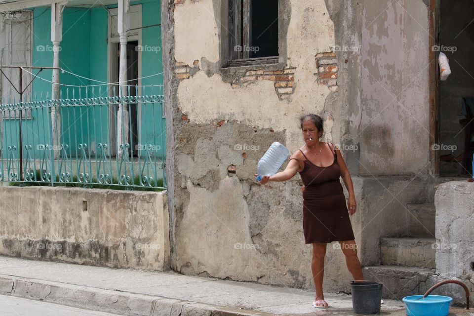 Cuban People.Woman collecting water in Guantanamo