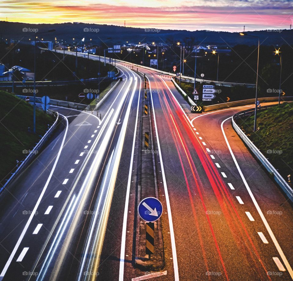 Trails of light from traffic on a stretch of Portuguese highway just after sunset