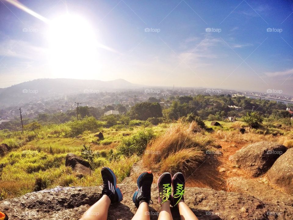 Lowsection of couple legs on rock