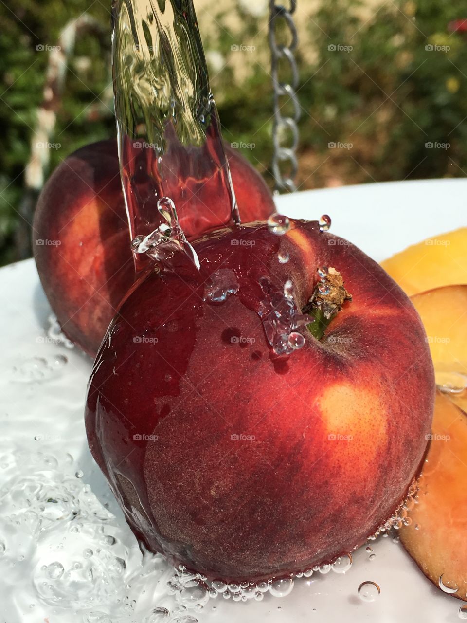 Water pouring over fresh picked nectarines