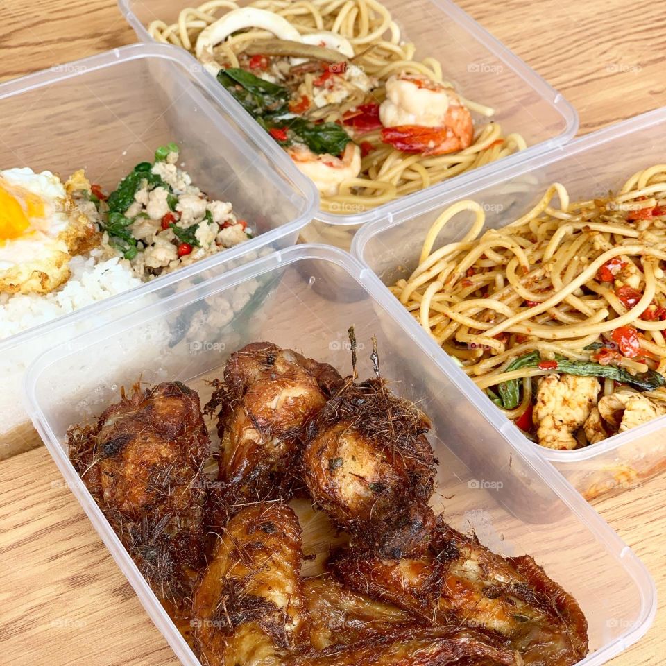 Spicy Thai western fusion meal with noodles , rice and chicken wings 