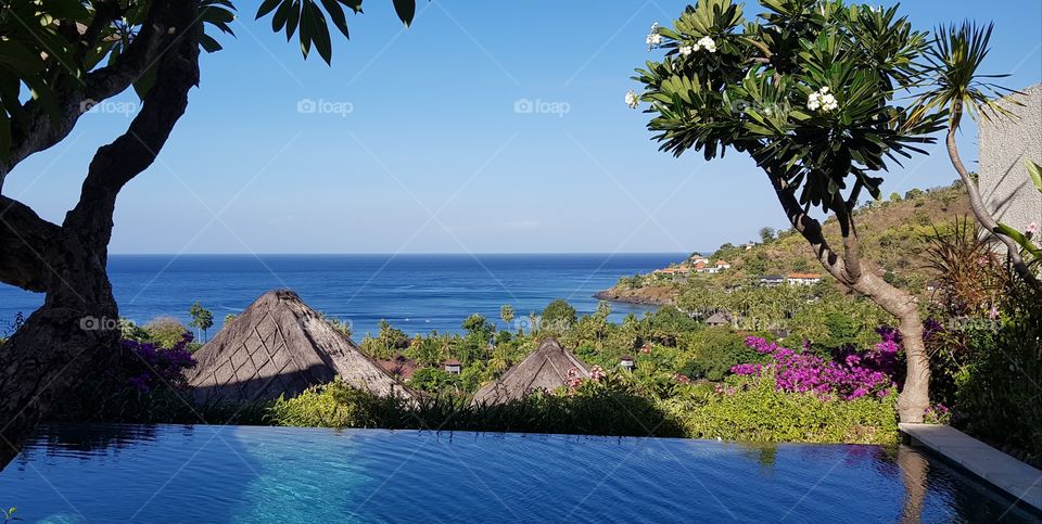 View across an infinity pool and out to sea in Bali