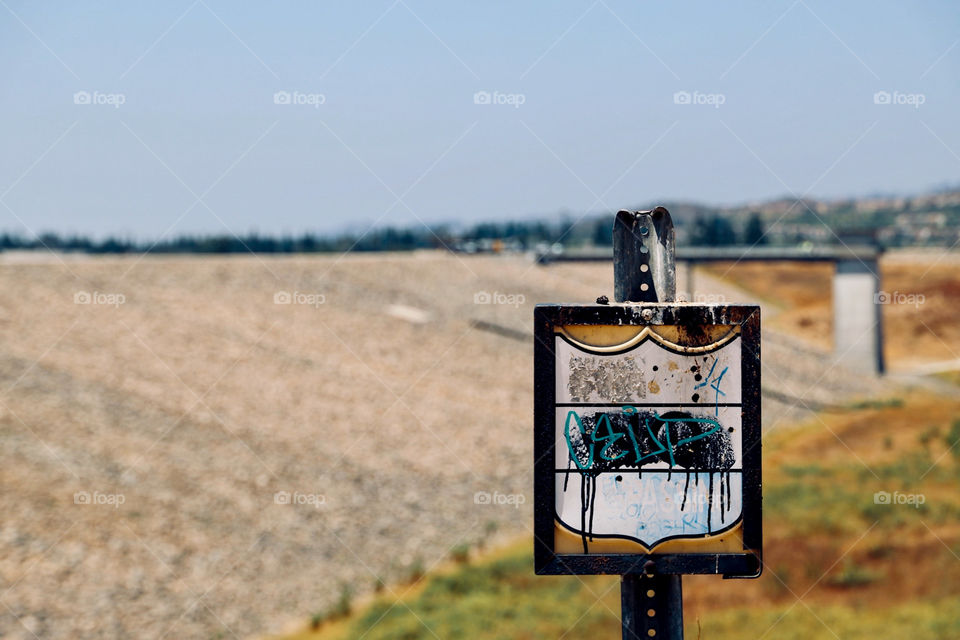 Weather beaten signage in front of a dam. Shot on Canon 6D Mark II 