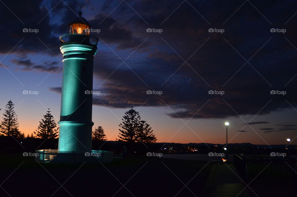 Lit up lighthouse @ sunset